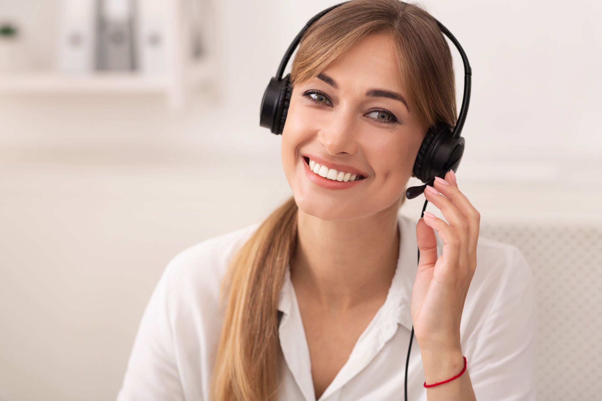 Hotline And Custoner Support. Smiling Woman In Headset Talking With Client Working In Call Center Office.